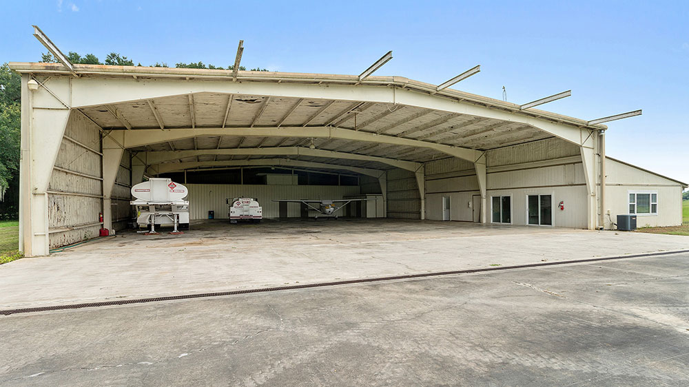 The extraordinary John Travolta house integrates a fully functional aircraft hangar directly into its residential master plan.