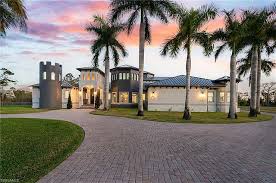 Exterior façade of John Travolta mansion in Florida featuring symmetrical design and wide veranda