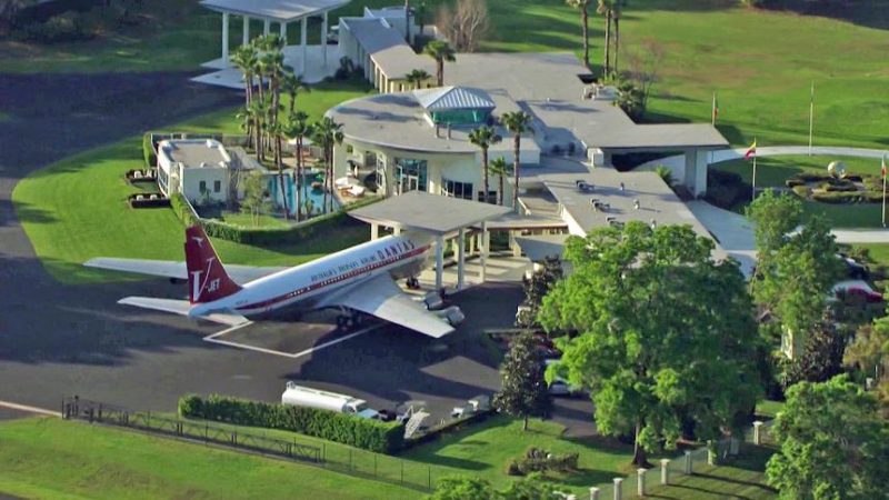 Landscape view of John Travolta house in Florida showing open lawns, private runway, and aviation estate planning